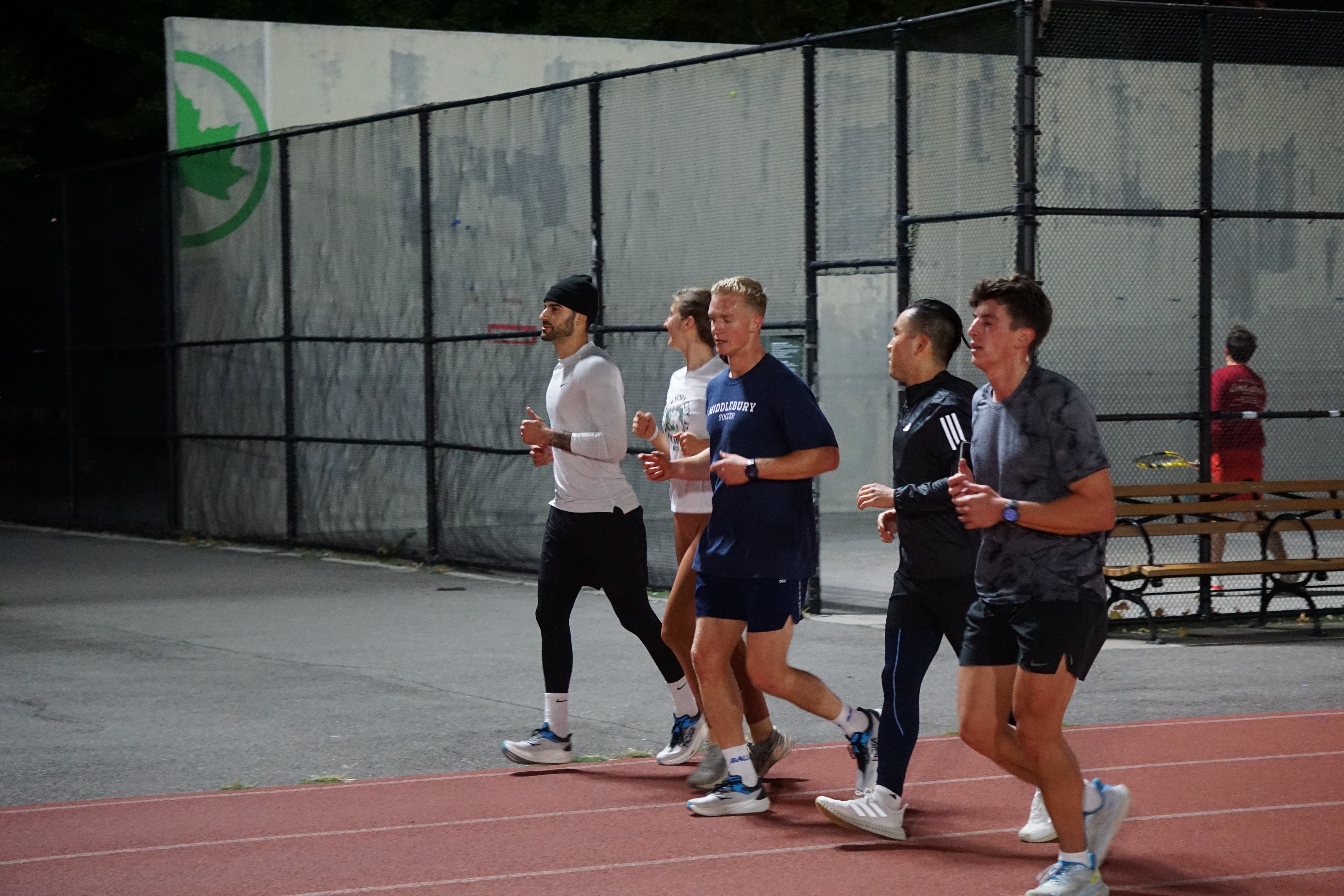 Group running on the track at night